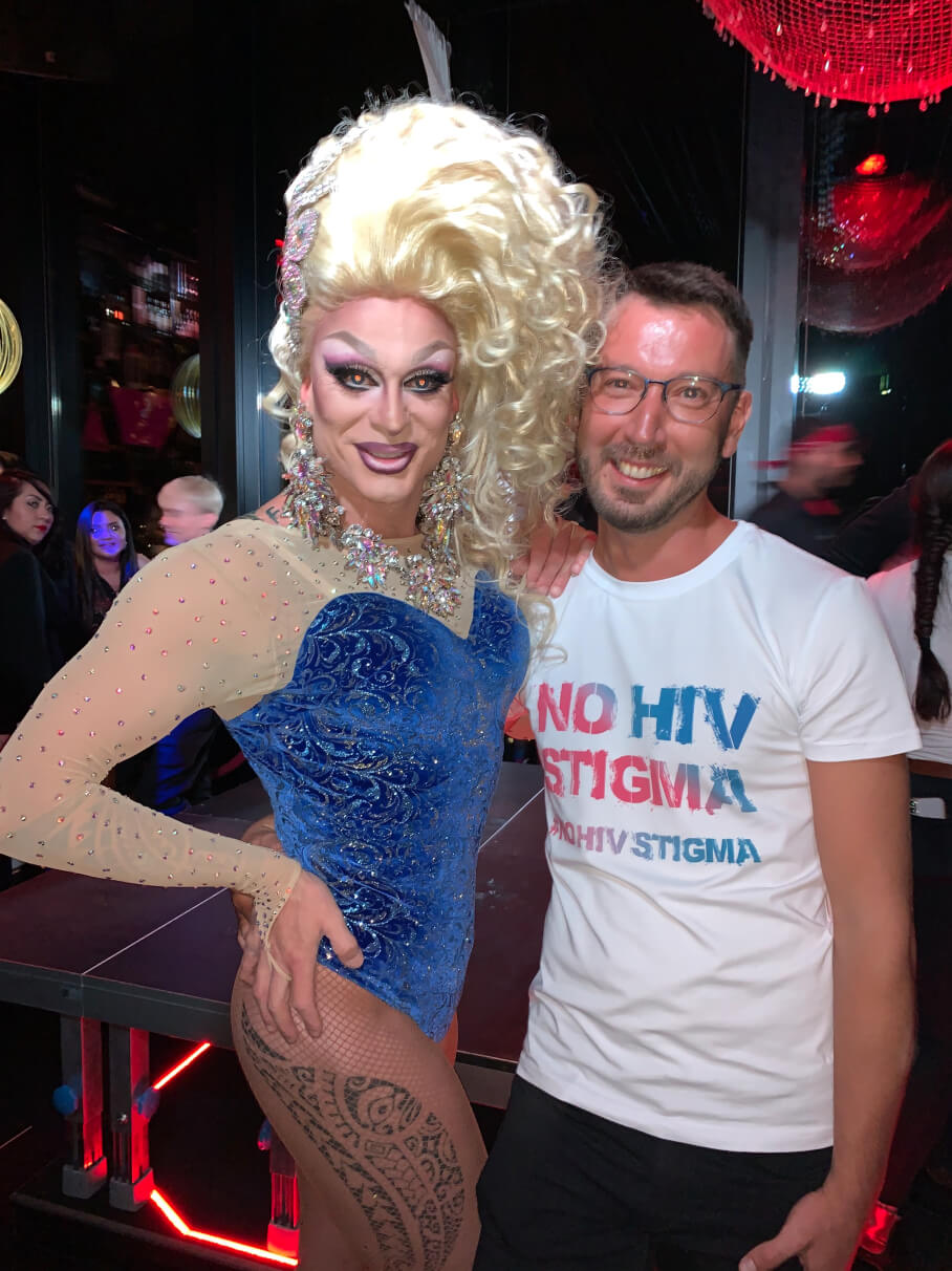 In the bar Rouge, Drag Queen Priscilla, Queen of Mykonos, urges to guests to participate in the NoHIVstigma campaign to dispel the fear of HIV.